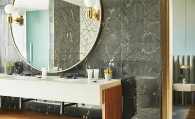 a bathroom with a sink and a large mirror at Grand Hyatt Barcelona in Barcelona