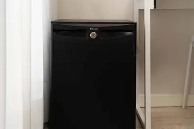 a black refrigerator in the corner of a room at Paral·lel in Barcelona