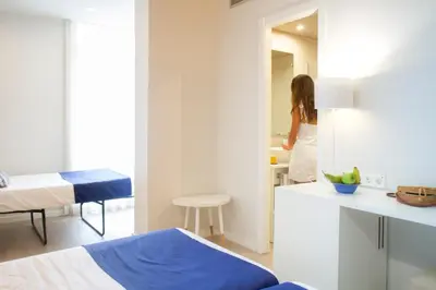 a woman is standing in a bathroom in a room at Ibersol Antemare - Adults Only in Sitges