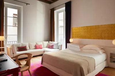 a bedroom with a large bed and a couch at Hotel Neri – Relais & Chateaux in Barcelona