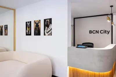 a reception desk in a room with a white couch at htop BCN City #htopEnjoy in Barcelona