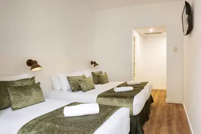 two beds in a room with white walls at htop BCN City #htopEnjoy in Barcelona