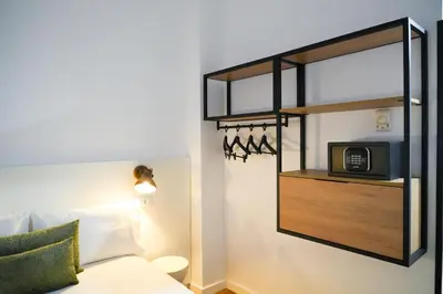 a bedroom with a bed and a mirror and a microwave at htop BCN City #htopEnjoy in Barcelona