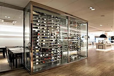 a wine cellar with a wall of wine bottles at Hotel Bernat II 4*Sup in Calella