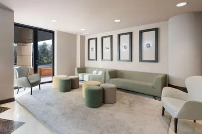 a living room with a couch and tables and chairs at Hotel Alimara in Barcelona