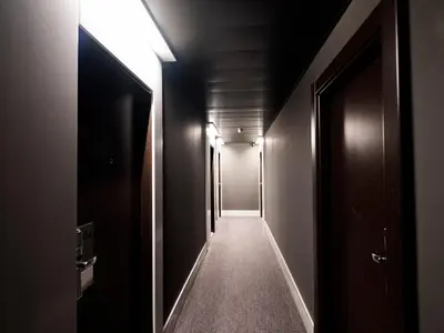 a dark hallway with a light at the end at HG City Suites Barcelona in Barcelona