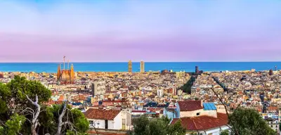 a view of a city with the ocean in the background at HG City Suites Barcelona in Barcelona