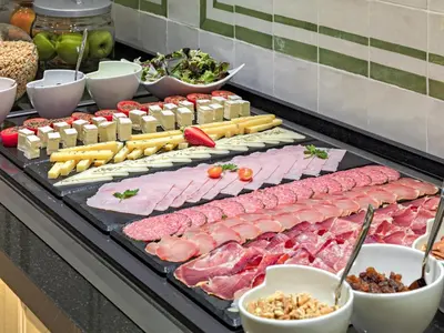 a buffet with many different types of meats and cheese at Boutique Hotel H10 Montcada in Barcelona
