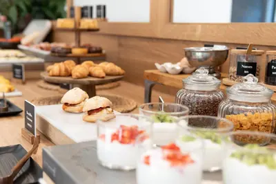 a buffet of food with sandwiches and other food items at Arenas Atiram Hotel in Barcelona