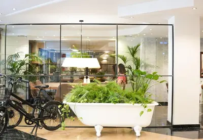 a large white tub filled with plants in a lobby at Arenas Atiram Hotel in Barcelona