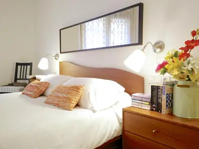 a bedroom with a white bed with two pillows at BizFlats Garden House in Barcelona