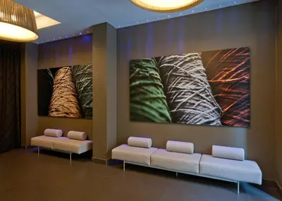 a waiting room with two couches and paintings on the wall at Hotel Constanza in Barcelona