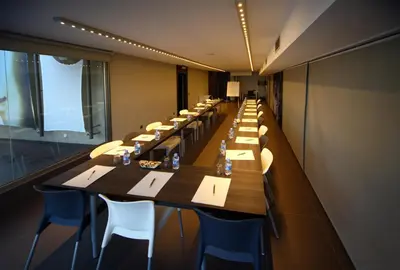 a long dining room with long tables and chairs at Hotel Constanza in Barcelona
