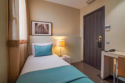 a hotel room with a bed and a door at Hotel Constanza in Barcelona