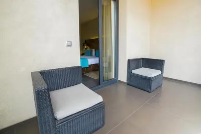 two chairs and a stool in a room at Hotel Constanza in Barcelona