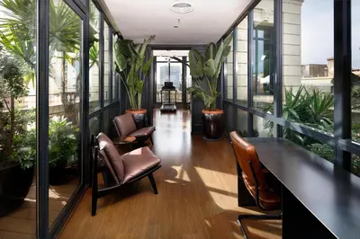 a balcony with chairs and plants on a building at Wilson Boutique Hotel in Barcelona