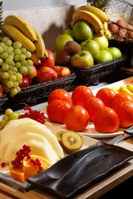 a table topped with baskets of fruits and vegetables at Wilson Boutique Hotel in Barcelona