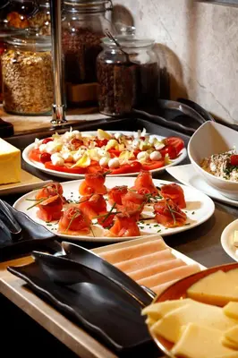 a buffet with three plates of food on a table at Wilson Boutique Hotel in Barcelona