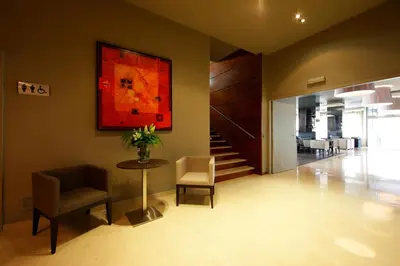 a lobby with a table and chairs and a painting at Attica 21 Barcelona Mar in Barcelona
