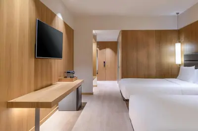 a hotel room with two beds and a tv at AC Hotel Diagonal L'Illa by Marriott in Barcelona