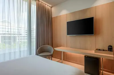 a hotel room with a bed and a television at AC Hotel Diagonal L'Illa by Marriott in Barcelona