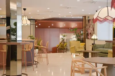 a lobby with tables and chairs in a building at Hotel Viladomat in Barcelona