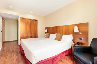 a hotel room with a large bed and a couch at Hotel Best Aranea in Barcelona