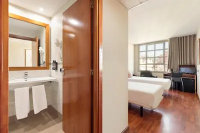 a bathroom with a sink and a toilet in a room at Hotel Best Aranea in Barcelona
