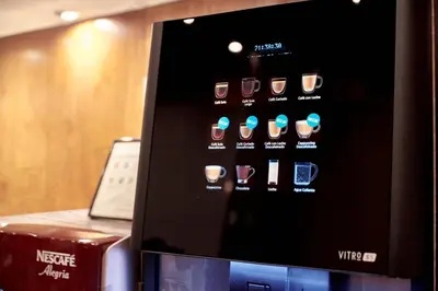 a microwave with a display of different cups of coffee at Garbi Millenni in Barcelona