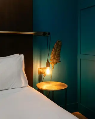 a bedroom with a bed and a table with a lamp at Hotel Ramblas Internacional in Barcelona