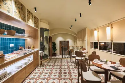a dining room with wooden tables and chairs at H10 Raco del Pi in Barcelona