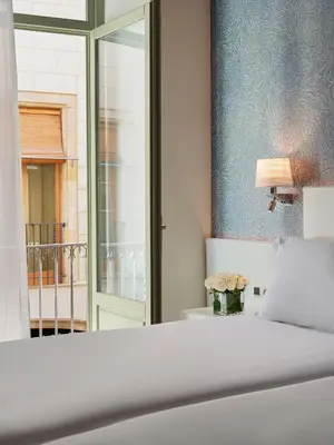 a hotel room with two beds and a balcony at H10 Raco del Pi in Barcelona