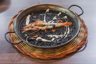a pan filled with food on top of a table at Abba Garden in Barcelona
