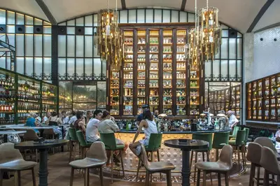a rendering of a restaurant with people sitting at tables at Habitat Apartments La Bohème in Barcelona