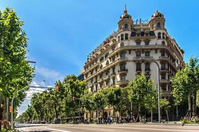 a large white building on a city street at Habitat Apartments La Bohème in Barcelona