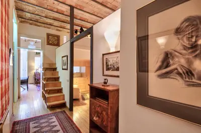 a hallway with a painting of a woman on the wall at Habitat Apartments La Bohème in Barcelona