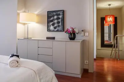 a bedroom with a dresser with a vase of flowers on it at Habitat Apartments Tessa in Barcelona