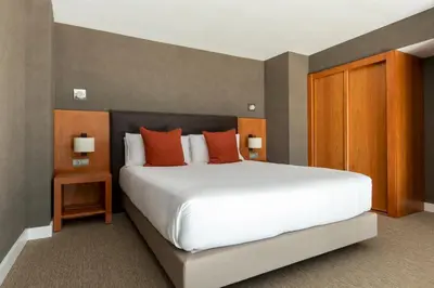 a bedroom with a large white bed with orange pillows at Acta Sant Just in Sant Just Desvern
