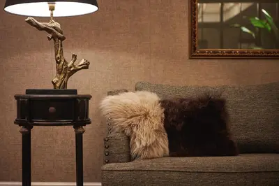 a dog sitting on a couch next to a lamp at Acta Splendid in Barcelona
