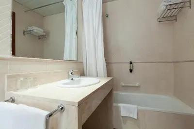 a bathroom with a sink and a tub and a mirror at ITC Barcelona By Soho Boutique in Barcelona