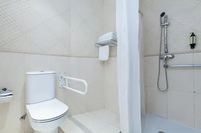 a white bathroom with a toilet and a shower at ITC Barcelona By Soho Boutique in Barcelona