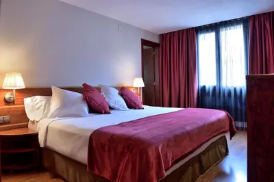 a bedroom with a large bed with red curtains at ITC Barcelona By Soho Boutique in Barcelona