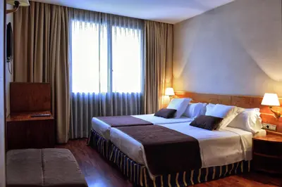 a hotel room with a large bed and a window at ITC Barcelona By Soho Boutique in Barcelona