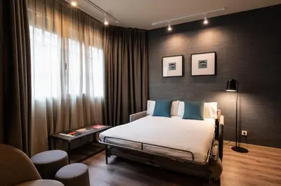 a bedroom with a bed and a window at Atenea Rekord Suites Barcelona in Barcelona