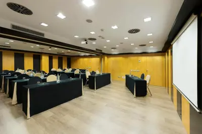 a conference room with desks and chairs and a whiteboard at Hotel Jazz in Barcelona