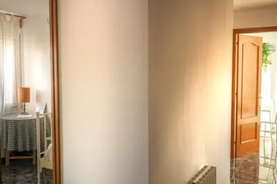 a room with a door and a table and a mirror at Habitación doble con Balcón - Casa rural compartida - Coliving in Torrellas de Foix