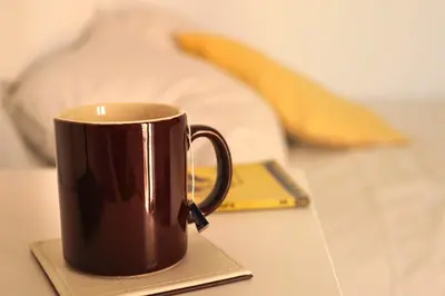 a brown coffee cup sitting on a table at Habitación doble con Balcón - Casa rural compartida - Coliving in Torrellas de Foix