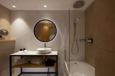 a bathroom with a sink and a shower and a mirror at Catalonia Diagonal Centro in Barcelona