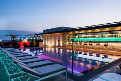 a group of chairs sitting next to a swimming pool at Catalonia Barcelona Plaza in Barcelona