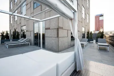 a bed on a balcony of a building at Catalonia Barcelona Plaza in Barcelona